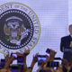 Image for article titled Trump Gives Speech in Front of Altered Presidential Seal Featuring Golf Clubs and ‘45 Is a Puppet’